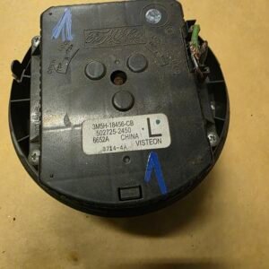 Black automotive electronic module with a white label reading CHINA VISTEON and part numbers; blue marker arrow on the surface and exposed wiring nearby on the right side.